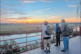  ?? AFP ?? So near, yet so far: Central American migrants observe the Rio Grande, the river along the border that divides the cities of Piedras Negras in Mexico and Eagle Pass in Texas, US.