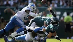  ?? MATT ROURKE — THE ASSOCIATED PRESS ?? Eagles’ Carson Wentz (11) is tackled by Detroit Lions’ Damon Harrison (98) during the second half.