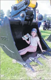  ??  ?? Millie Austin, nine, from Canterbury seeks sanctuary from the sun in a digger claw