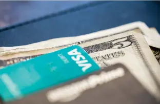  ?? AP FILE PHOTO/JENNY KANE ?? U.S. currency and credit cards sit on a table at a restaurant in New Orleans. Even if you have no plans to borrow money, good credit is important. It’s a safety net in a crisis and gives you options you would not have otherwise.