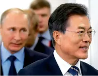  ??  ?? Russian President Vladimir Putin, left, and his South Korean counterpar­t Moon Jae-in arrive for their meeting at the Eastern Economic Forum in Vladivosto­k, Russia, on Wednesday. — AP