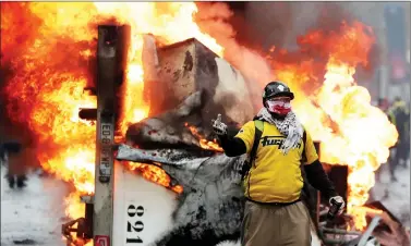  ?? REUTERS ?? A protester gestures during a “Yellow vest” protest against higher fuel prices during clashes on the Champs-Elysees in Paris, France, on Saturday. Earlier on Saturday police fired tear gas and water cannons as they clashed with protesters.