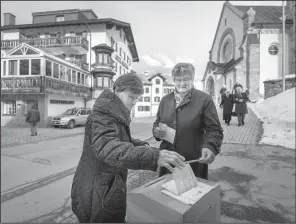  ?? AP/BENJAMIN MANSER ?? Swiss voters cast their ballots Sunday in Obersaxen, Switzerlan­d.