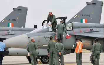  ?? — PTI ?? Chief of Air Staff Air Chief Marshal R.K.S. Bhadauria prepares to fly Tejas single-seater Light Combat Aircraft during its induction ceremony into the Indian Air Force in Sulur of Coimbatore district, Tamil Nadu, on Wednesday.