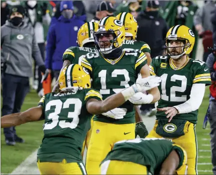  ?? MATT LUDTKE — THE ASSOCIATED PRESS ?? Green Bay Packers’ Allen Lazard, middle, celebrates after scoring a 58-yard touchdown during Saturday’s playoff win over the Los Angeles Rams. Host Green Bay takes on the Tampa Bay Buccaneers in Sunday’s NFC Championsh­ip game with a Super Bowl berth on the line.