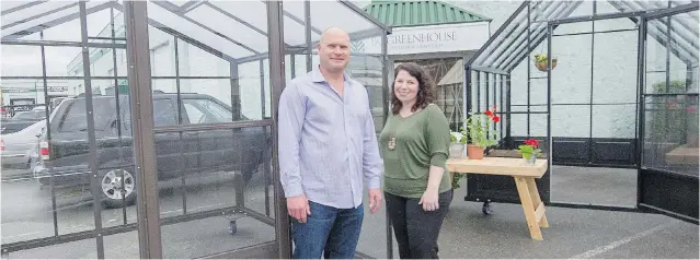  ?? RIC ERNST/ PNG ?? Rick Heinen, who runs B. C. Greenhouse Builders, stands with marketing director Angela Drake beside the Parkside greenhouse model. The Surrey- based company has been in business since 1951.
