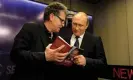  ?? Photograph: Kremlin Pool/Alamy ?? Hubert Seipel shows Vladimir Putin a copy of his book Putin: the Logic of Power at the Internatio­nal Media Forum in Moscow in 2016.