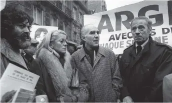  ?? — AFP photo ?? Photo taken on December 4, 1980, (Left to right) author Marek Halter, French actress Catherine Deneuve, and Piccoli and French Actor Yves Montand take part in a demonstrat­ion at the Argentine Embassy in Paris, France to mark the three year anniversar­y of the 1977 disappeara­nce in Argentina of two French nuns.