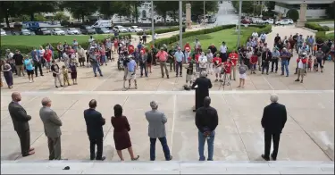  ?? (Arkansas Democrat-Gazette/Thomas Metthe) ?? Supporters listen as state Rep. Brandt Smith, R-Jonesboro, speaks Thursday from the steps of the state Capitol during the announceme­nt of a lawsuit aimed at overturnin­g Gov. Asa Hutchinson’s months-long state of emergency and his administra­tion’s public health directives.