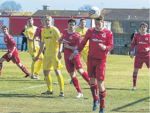  ??  ?? Carnoustie clear their lines against Bonnyrigg (yellow). The Gowfers lost the EoS Cup clash 3-2 at Laing Park.