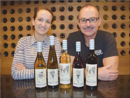  ?? STEVE MACNAULL/The Okanagan Saturday ?? Winemaker Sydney Valentino, left, and wine expert Kim Davies show off the Conviction Winery line up, which is replacing the Calona Wines label.