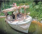  ??  ?? Chimpanzee­s have taken over the wrecked boat of a safari expedition on the Jungle Cruise at Disneyland Park.