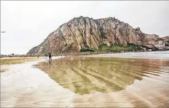  ?? Ricardo DeAratanha
Los Angeles Times ?? THE CRAGGY OUTLINE of 576-foot Morro Rock is reflected on the shoreline. The Salinan Indians and Northern Chumash have taken their feud over the Central California landmark into the legal arena.