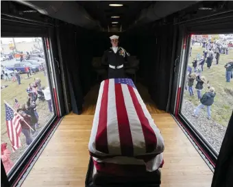  ?? AP ?? STATELY SENDOFF: The flag-draped casket of former President George H.W. Bush passes through Magnolia, Texas, yesterday along the route from Spring to College Station for his burial.