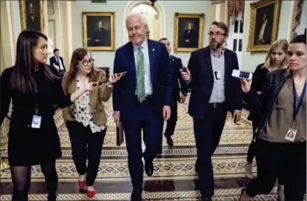  ?? ANDREW HARNIK — THE ASSOCIATED PRESS ?? Senate Majority Whip Sen. John Cornyn, R-Texas, speaks to reporters as he walks to the Senate Chamber at the Capitol in Washington, Monday after the Senate reached an agreement to advance a bill ending government shutdown.