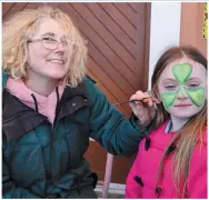  ??  ?? ABOVE: Erin Milligan had her face painted by Amanda Wright at the Rathmore St Patrick’s Parade.