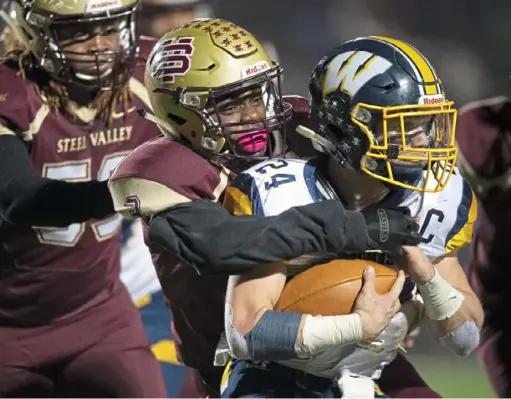  ?? Steph Chambers/Post-Gazette ?? Steel Valley’s Eshawn Carter brings down Wilmington’s Cameron Marett in the PIAA Class 2A semifinals Friday night at Ambridge.