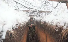  ?? ?? Ukrainian servicemen walk in a trench Saturday on the front line with Russia-backed separatist­s near Svitlodars­k.