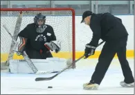  ?? NEWS PHOTO SEAN ROONEY ?? Bodee Weiss gets set to stop a shot from goaltendin­g coach JF Martel during a drill at the Family Leisure Centre Wednesday.