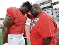  ?? Eric Christian Smith / Contributo­r ?? Keeping to a family tradition, Atascocita offensive tackle Kenyon Green, left, prays with his father, Henry, before a scrimmage against The Woodlands on Friday.