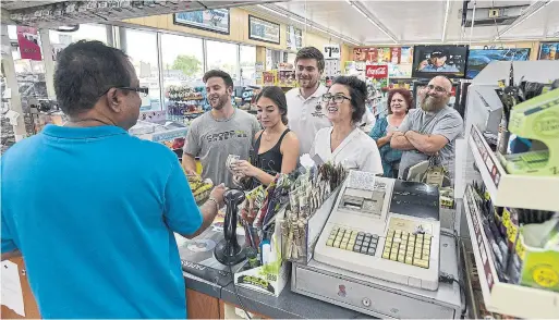  ?? MICHAEL LAUGHLIN THE ASSOCIATED PRESS ?? With a jackpot at a record-setting $1 billion, stories about how “money doesn’t buy happiness” come across as ridiculous.