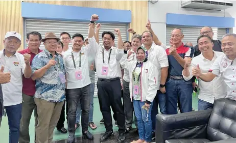  ?? ?? Lukanisman (front, fourth left), flanked by Ripin and Rosey, celebrates his victory with supporters.