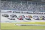  ?? JOHN BAZEMORE — THE ASSOCIATED PRESS ?? Denny Hamlin (11) and Kurt Busch (1) lead the field to the start of the YellaWood 500NASCAR auto race at Talladega Superspeed­way, Sunday, Oct. 4, 2020, in Talladega, Ala.