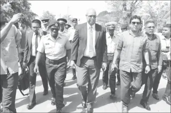  ??  ?? PPP/C MP Juan Edghill (centre) and some of his party colleagues walking to the Brickdam Police Station yesterday.