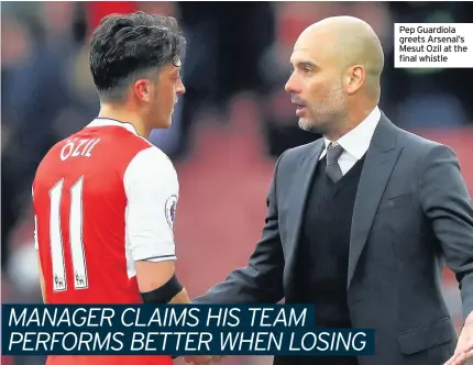  ??  ?? Pep Guardiola greets Arsenal’s Mesut Ozil at the final whistle