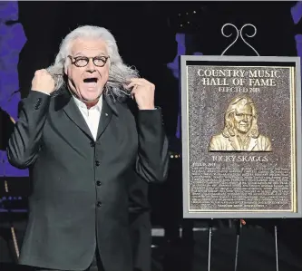  ?? TERRY WYATT GETTY ?? Ricky Skaggs is presented with his Hall of Fame plaque during the 2018 Country Music Hall of Fame and Museum Medallion Ceremony honoring inductees Johnny Gimble, Skaggs and Dottie West.