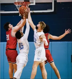 ?? JAMES BEAVER/FOR MEDIANEWS GROUP ?? Souderton’s Aleks Smith (21) reaches up for a rebound with North Penn’s Tehran Wright (45) and Josh Jones (23) battling for position in a reent game.