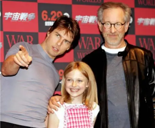  ??  ?? A young Dakota with Tom Cruise and Steven Spielberg (Getty)