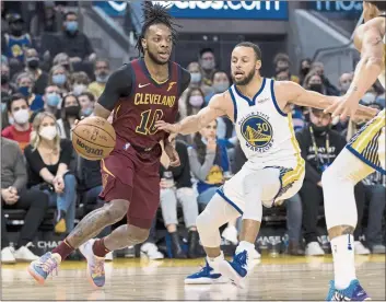  ?? JOHN HEFTI — THE ASSOCIATED PRESS ?? Cleveland Cavaliers guard Darius Garland (10) drives past Golden State Warriors guard Stephen Curry (30) during the first half Sunday in San Francisco.