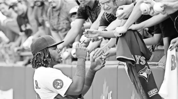  ?? NATHAN DENETTE/AP ?? Bisons third baseman Vladimir Guerrero Jr. is a big Blue Jays fans favorite, here signing before a Class AAA game in Buffalo. His 2018 stats in Classes AA and AAA: .382 average, 1.077 OPS, 20 homers, 78 RBI, 67 runs, 225 total bases.