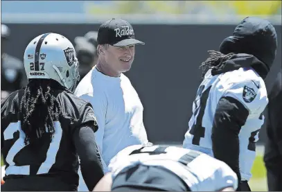  ?? Rich Pedroncell­i ?? The Associated Press Coach Jon Gruden eyes an improved ground attack, including contributi­ons from running back Marshawn Lynch, right.