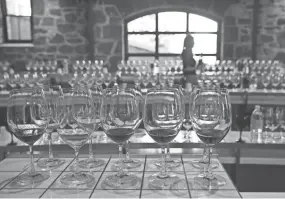  ?? ERIC RISBERG/AP ?? A server fills wine glasses at a winery in St. Helena, California. While the new tax law gave small-business owners new tax breaks, Congress took back deductions for entertainm­ent expenses.