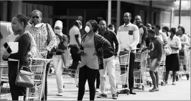  ??  ?? People queue to shop in Harare ahead of a nationwide lockdown to limit the spread of coronaviru­s. (Photo: Al Jazeera)