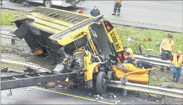  ?? BOB KARP — THE DAILY RECORD ?? Emergency personnel examine a school bus after it collided with a dump truck inNewJerse­y Thursday, injuringmu­ltiple people.