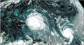  ?? NOAA 2017 ?? A satellite image shows the eye of Hurricanes Irma, left, and Jose in the Atlantic Ocean. Six major hurricanes spun around the Atlantic in 2017, including Harvey, Irma and Maria.