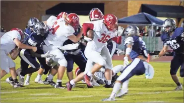  ??  ?? LFO sophomore running back Benji Valdes powers through the Coahulla Creek defense on his way to a team-high 65 yards in the Warriors’ 29-10 road win on Friday night.