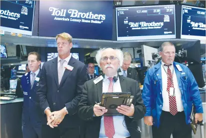  ?? (Brendan McDermid/Reuters) ?? TRADERS PAUSE for a moment of silence for the fallen police officers in Baton Rouge, Louisiana, before the opening bell on the floor of the New York Stock Exchange yesterday. As Turkish authoritie­s sought to retaliate for a faction of the armed forces’...