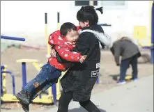  ??  ?? Older children help look after younger ones at the Village in Shunyi.