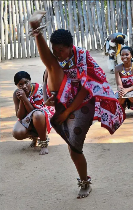  ?? — Photos: CYNTHIA EE ?? A vigorous dance, complete with high- kicks, being performed at the Mantenga Cultural Village, Swaziland.