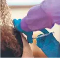  ?? TRENT SPRAGUE/THE VIRGINIAN-PILOT ?? A nurse receives a booster dose of the COVID-19 vaccine during a vaccinatio­n drive on Tuesday in Norfolk, Virginia.