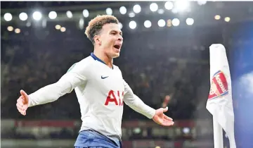 ?? — AFP photo ?? Tottenham's Dele Alli was struck by a bottle after scoring against Arsenal in their League Cup quarter-final.