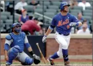  ?? AP photo ?? Kirk Nieuwenhui­s follows flight of game-winning, three-run home run in ninth inning during Mets’ 4-3 win over Cubs.
