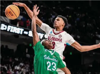  ?? Photos by Brett Coomer/Staff photograph­er ?? Alabama’s Rylan Griffen added two blocks, including this one on Texas A&M-CC’s Ross Williams, to his five points. Griffen had one of Alabama’s 15 3-pointers.