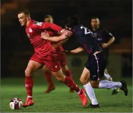  ??  ?? The influentia­l Michael O’Connor holding off Wexford FC defender, Luke Turner.