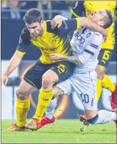  ??  ?? Dortmund's defender Sokratis (L) and Bergamo's Alejandro Gomez vie for the ball during a match in Dortmund.