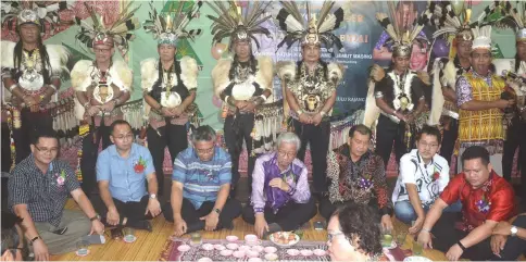  ??  ?? Masing (seated, centre) takes part in the traditiona­l ‘miring’ (bless-seeking ritual). With him from left are Jabang, Galong, Nyabong, Ugak, Philimon and Kudi.